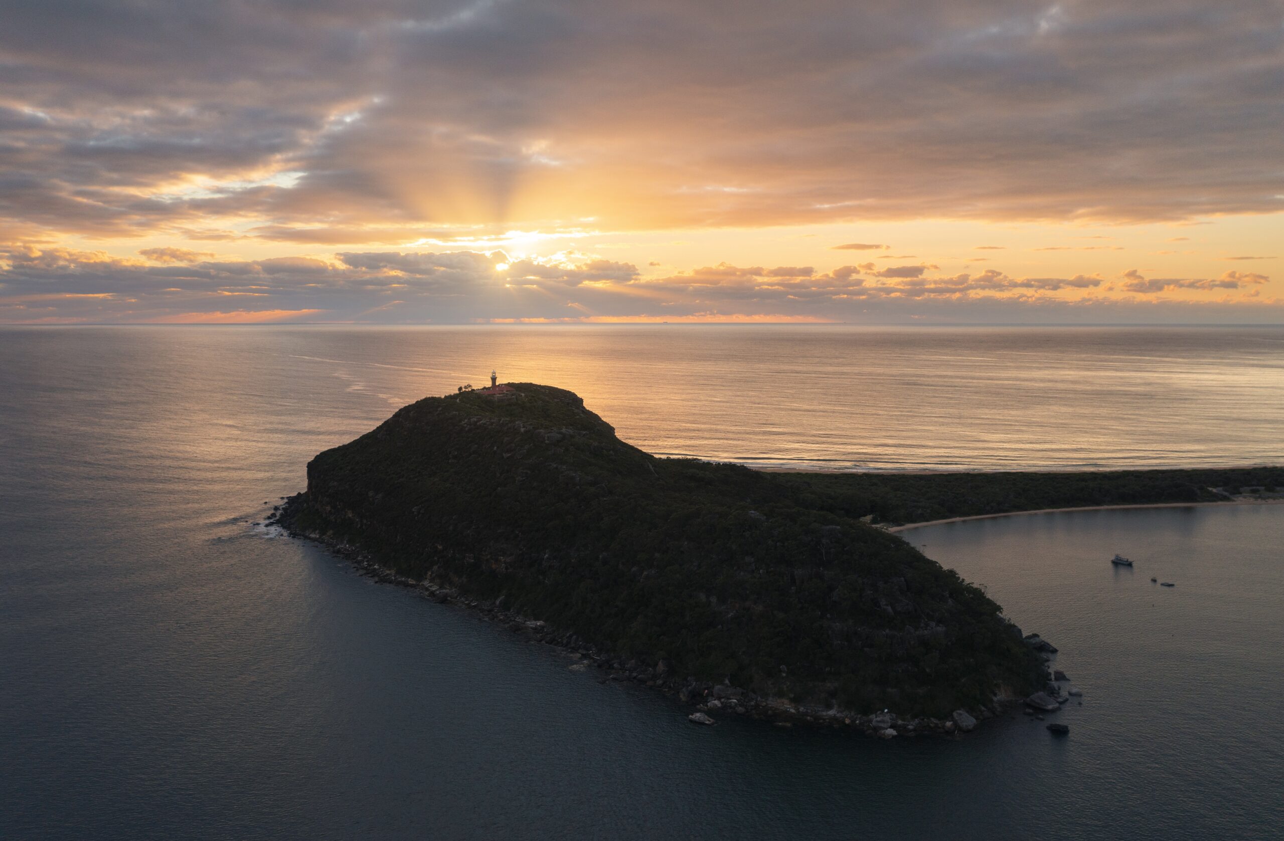 Sun rising over Barrenjoey Headland, Palm Beach.